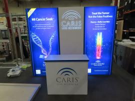 Gravitee Modular Backlit Exhibit with Tension Fabric Graphics, Backlit Press Thru Logo, and Reception Counter with Locking Storage